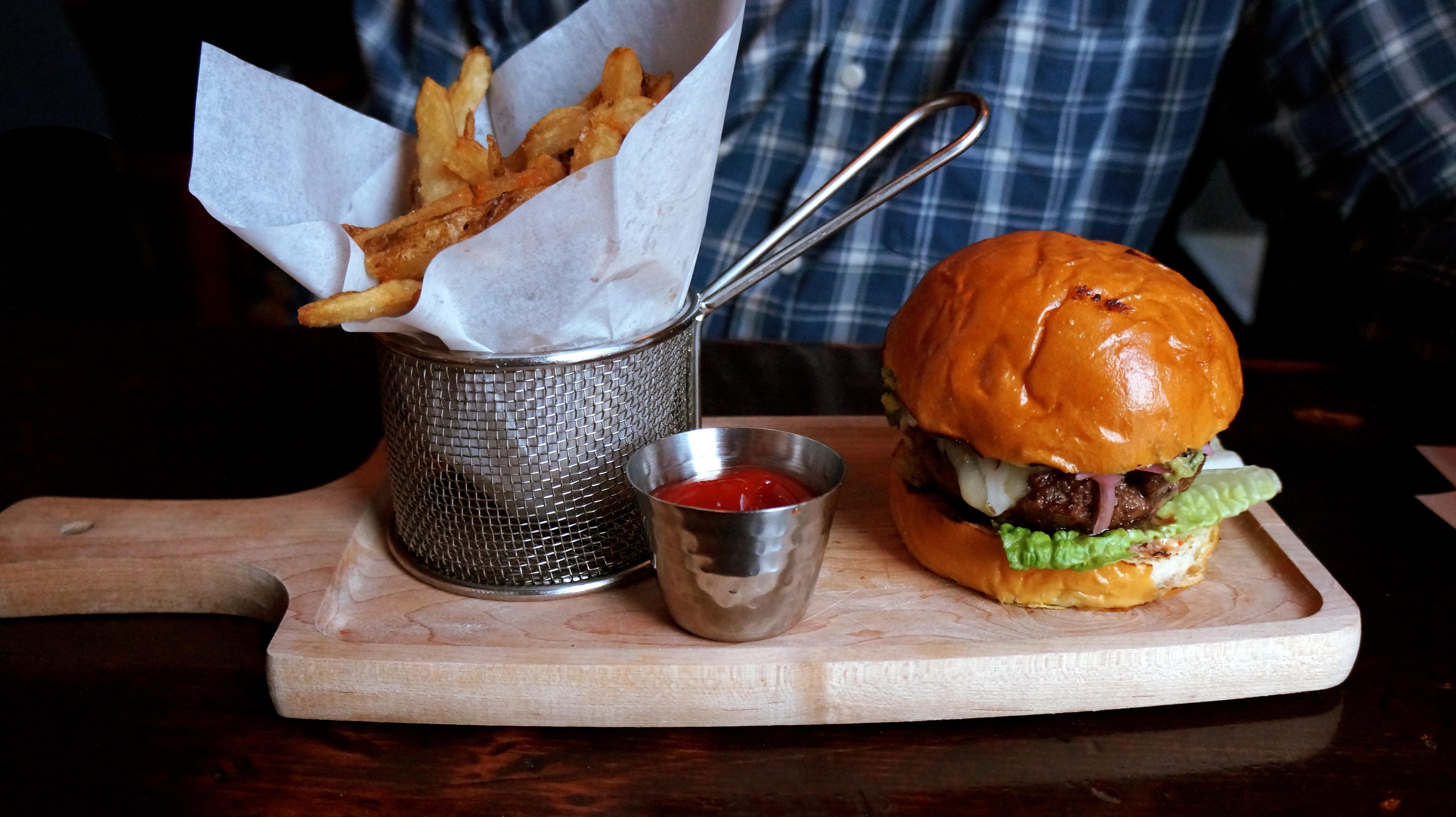cutting board with burger and fries