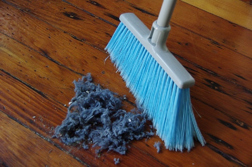 broom with pile of dust